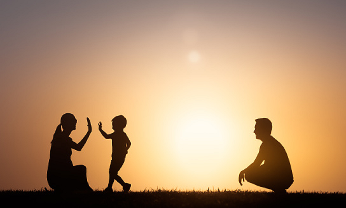 A silhouette image of a family enjoying the nature.